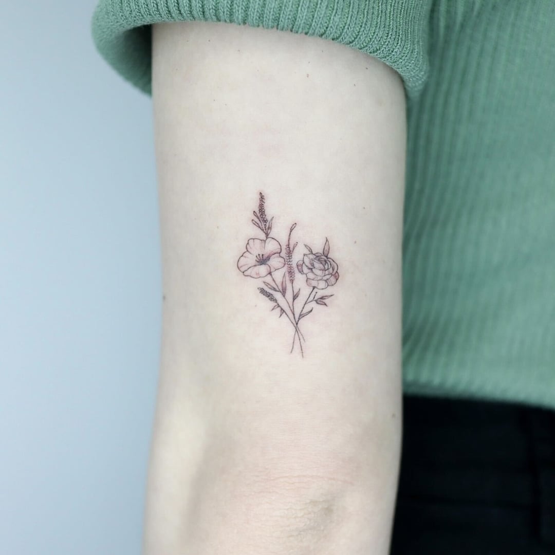 Tattoo of flowers on forearm with soft colors