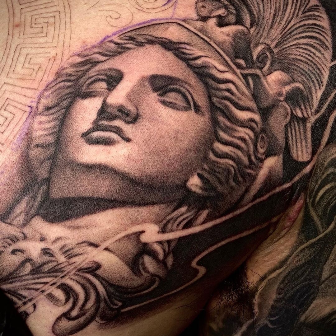 Detailed tattoo of a classical statue on skin