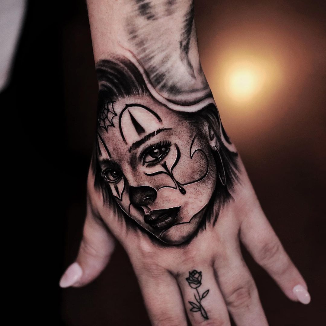 Detailed hand tattoo showcasing a woman's face, artistic style.