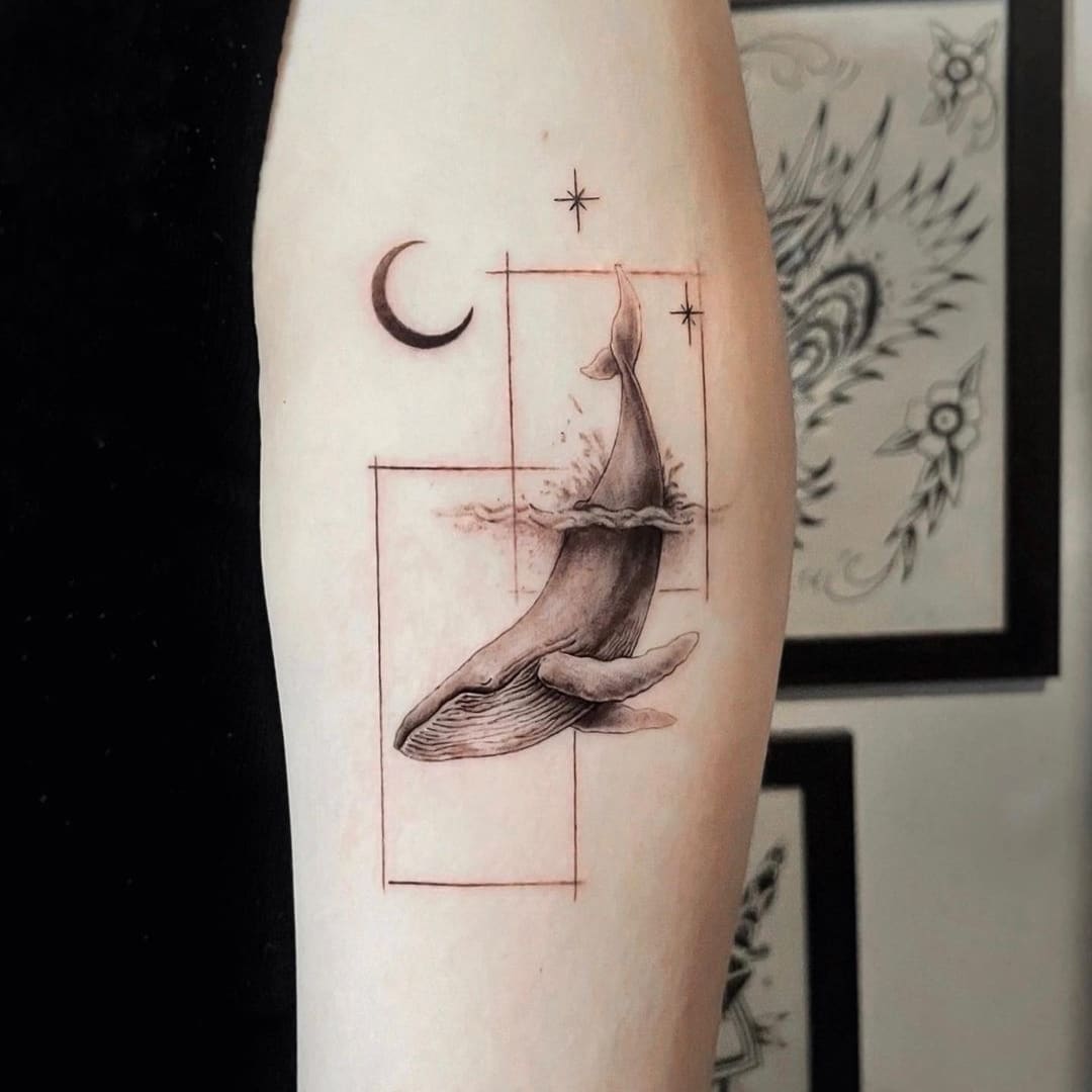 Detailed tattoo of a whale and celestial elements