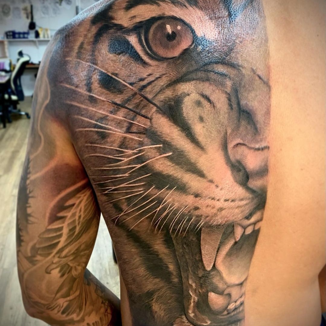 Detailed tiger tattoo on a person's arm
