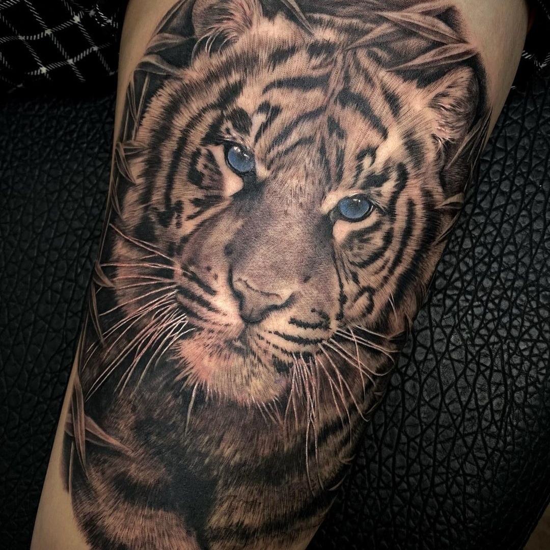 Highly detailed tattoo of a tiger's face on a person's skin