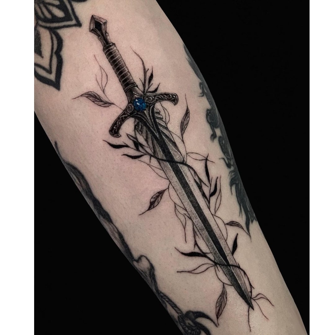 Intricate tattoo design of a sword entwined with vines.