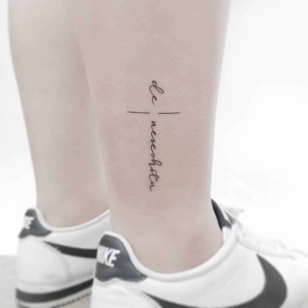 Minimalist tattoo on calf with script text