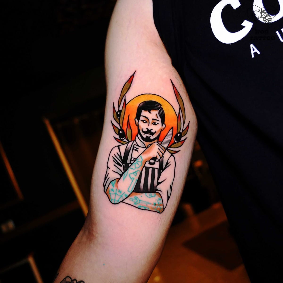 Colorful tattoo of a man with a mustache and wings