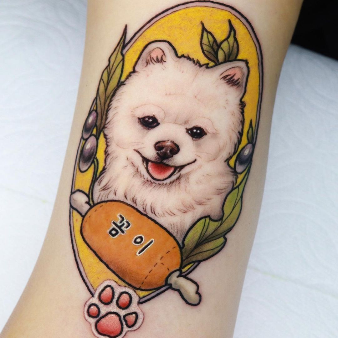 Tattoo of a fluffy dog with a joyful expression.